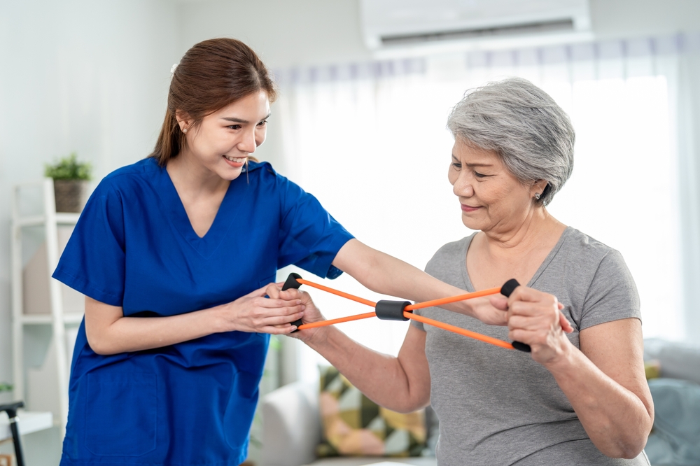 Elderly,Asian,Woman,Receive,Physical,Therapy,With,Support,Of,Caregiver.